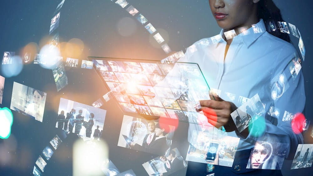 a woman holding a tablet with images on it