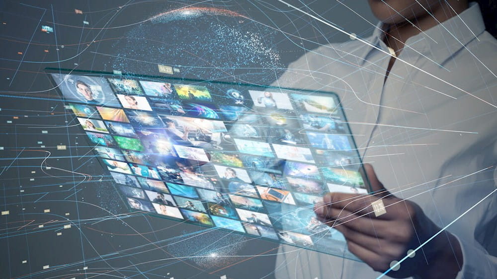 a woman holding a tablet with a lot of images on it