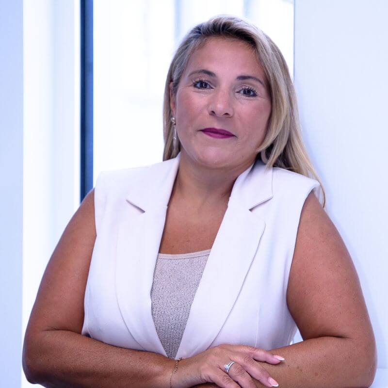 a woman leaning against a wall