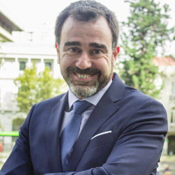 a smiling man in a suit and tie