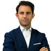 a man in a suit posing for a photo