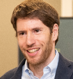 a smiling man in a suit