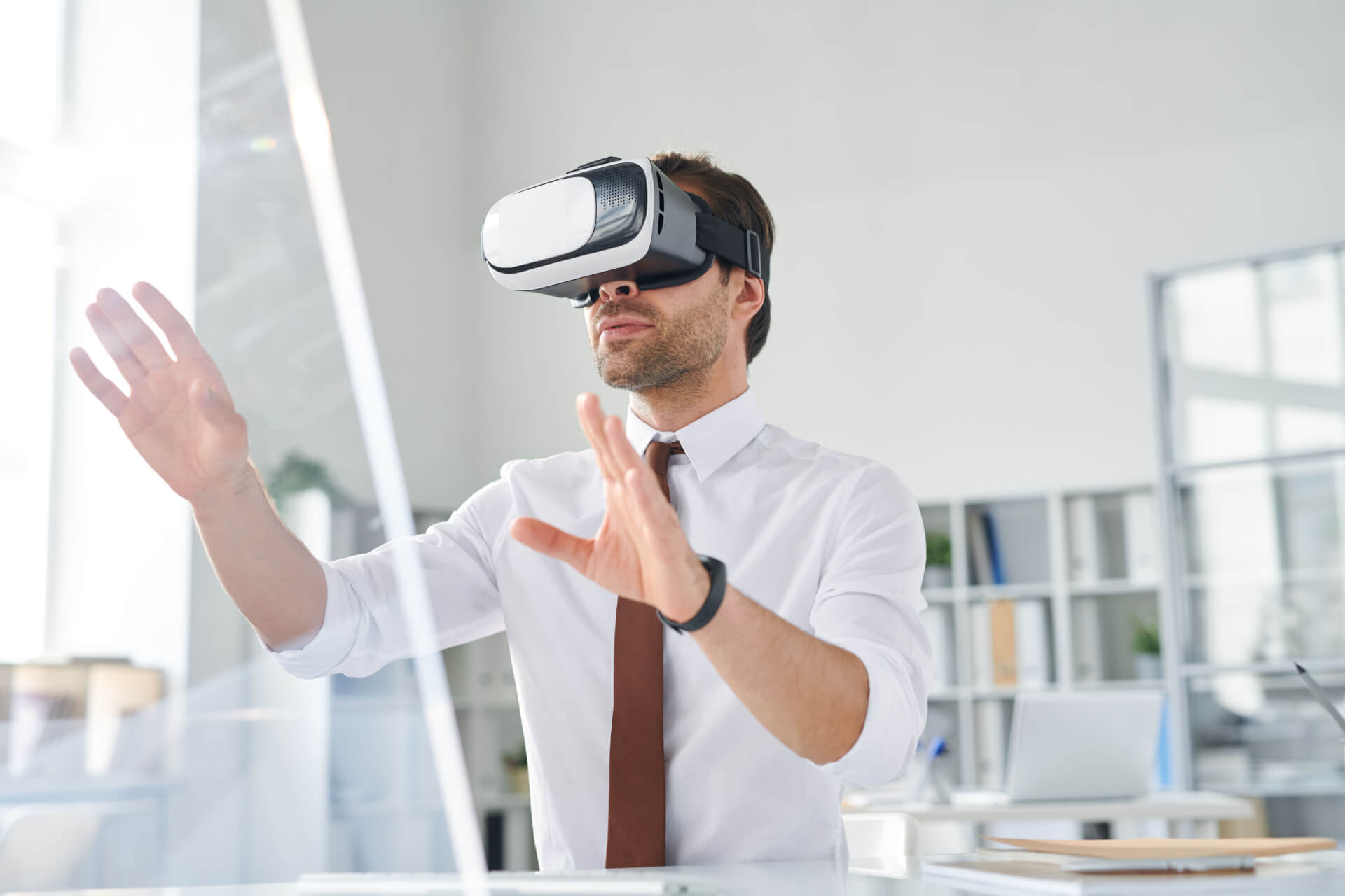 young-businessman-with-vr-goggle-watching-virtual