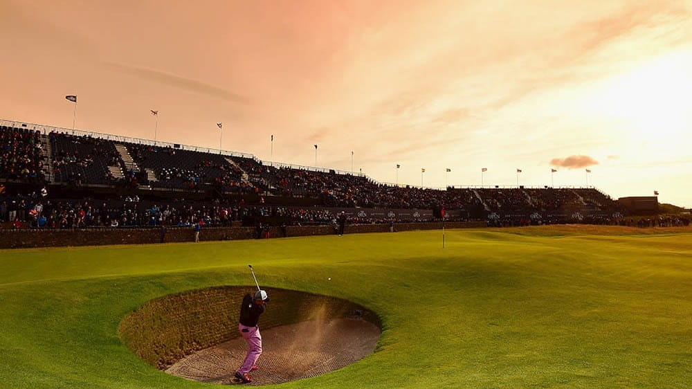 Golfer at the The Open at sunset in a bunker