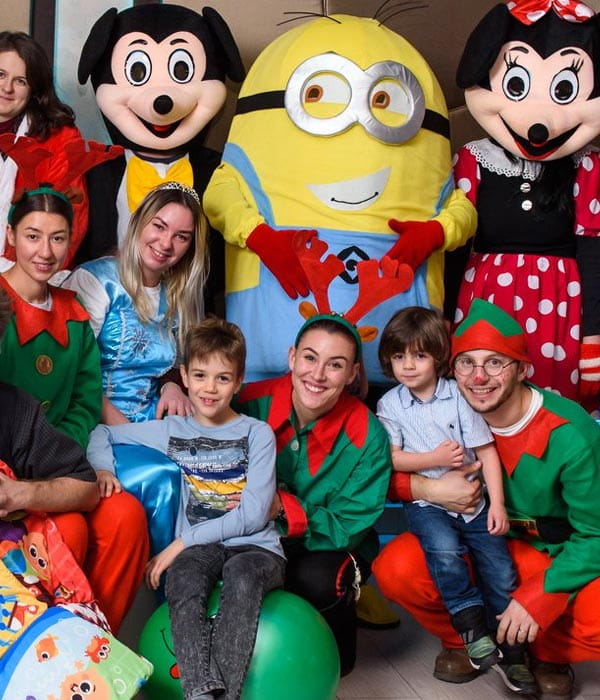 a group of people posing with minions