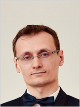 a man wearing glasses and a bow tie