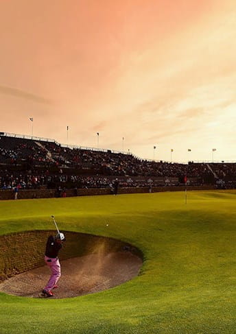 Golfer at the The Open at sunset in a bunker