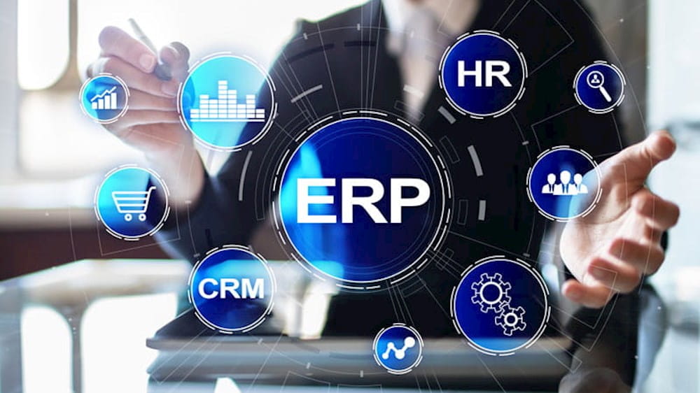 a business woman is pointing at erp icons on a table