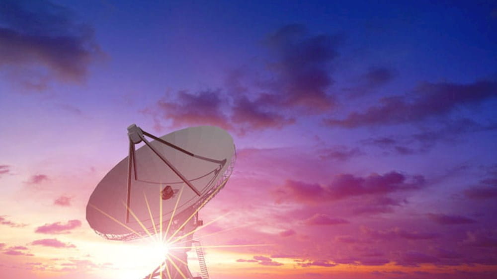 a satellite dish at sunset