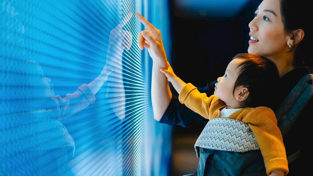 Woman and child looking at a screen