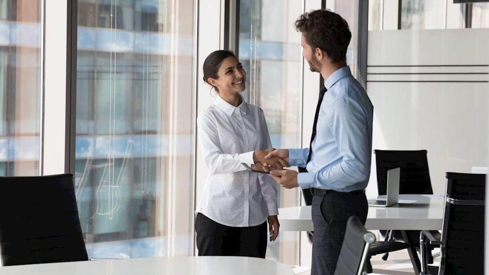 Man and woman speaking in the office