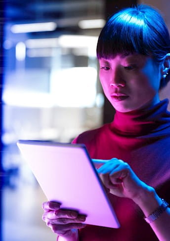 Woman writing on tablet