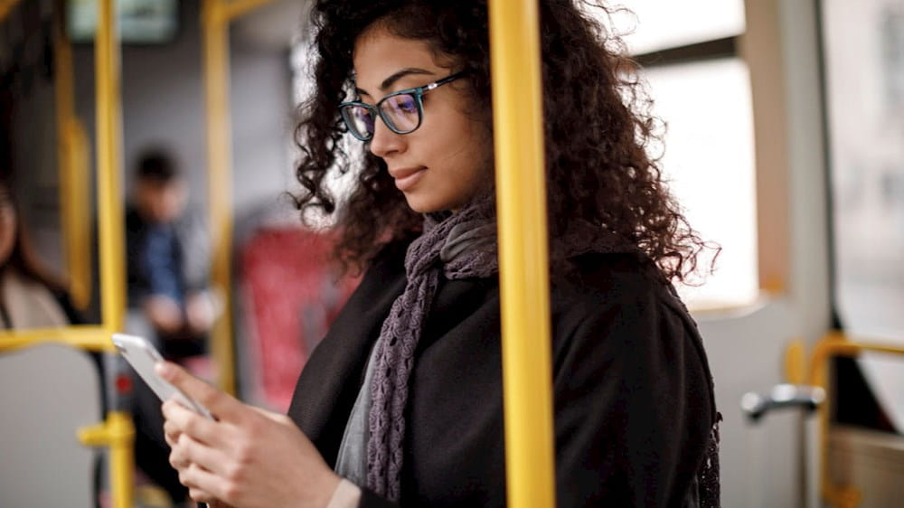 woman on the subway using her phone