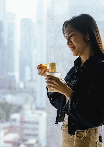 woman eating at a window