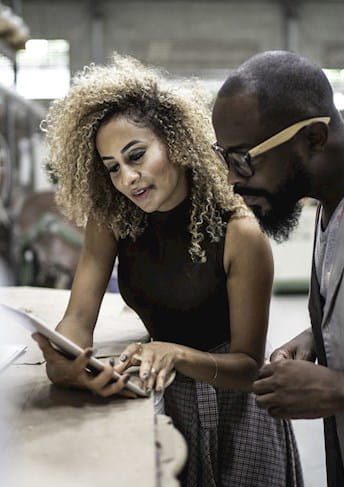 woman and man looking at a cell phone