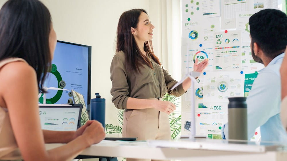 People in the office looking at a graph on a whiteboard