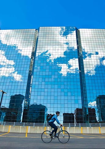 Tall modern glass building and blue sky