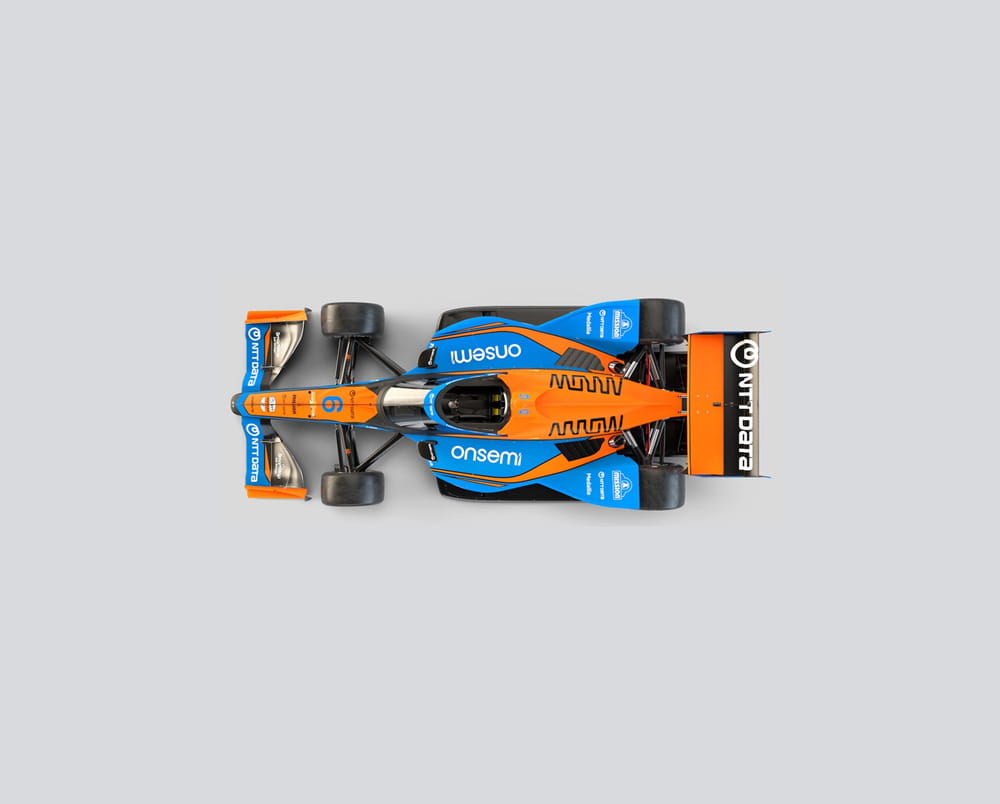 an orange and blue racing car on a white background