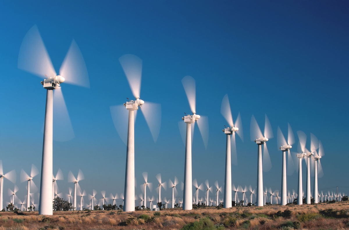 a group of wind turbines in a field