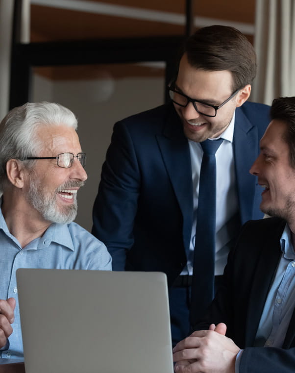 a group of business men and women working together on a laptop