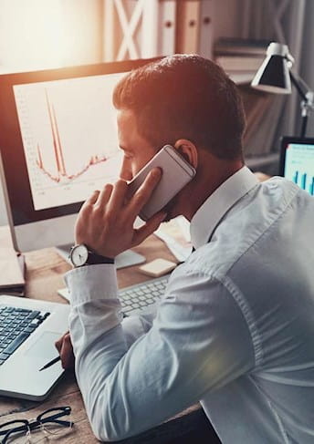 a businessman talking on the phone at his desk