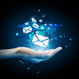 a person's hand holding an email