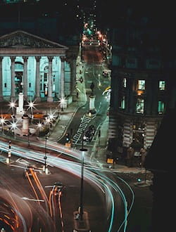 London Bank area in London at night with time-lapse so that car lights are lines