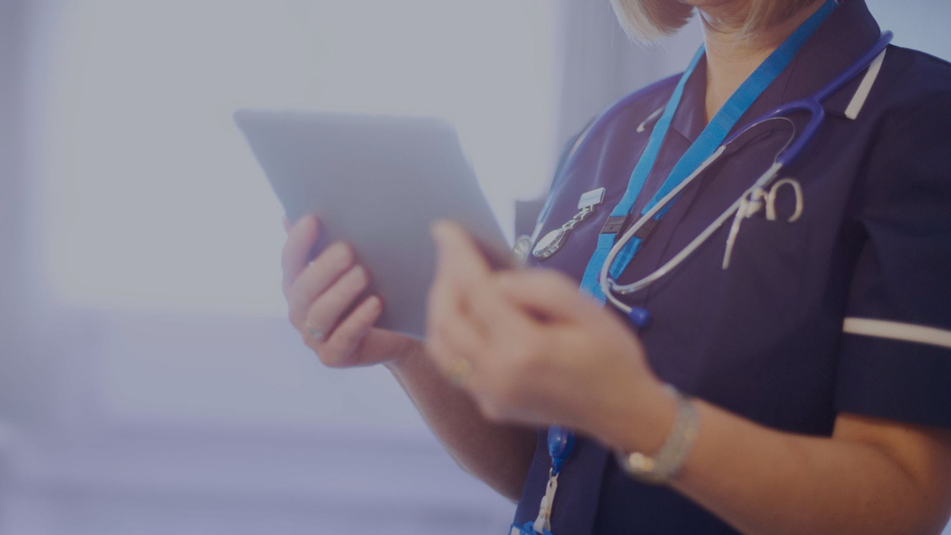 a nurse is holding a tablet