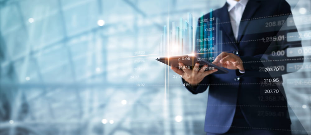 Man in suit using tablet with graphic overlayed on top.