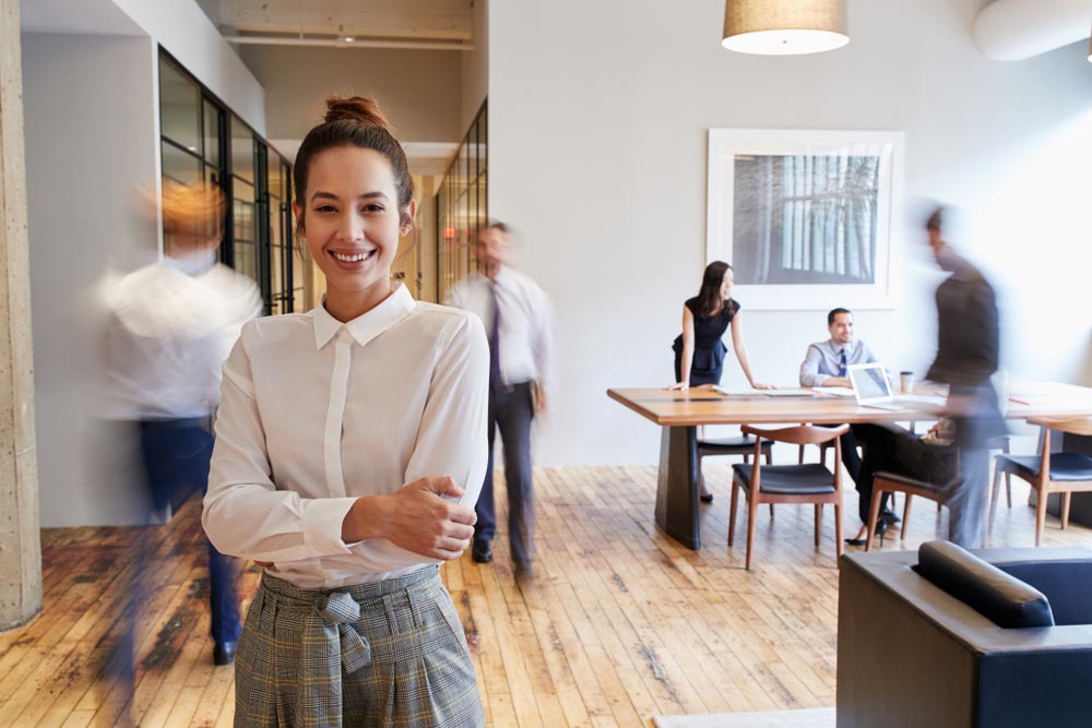 a smiling business woman in an office