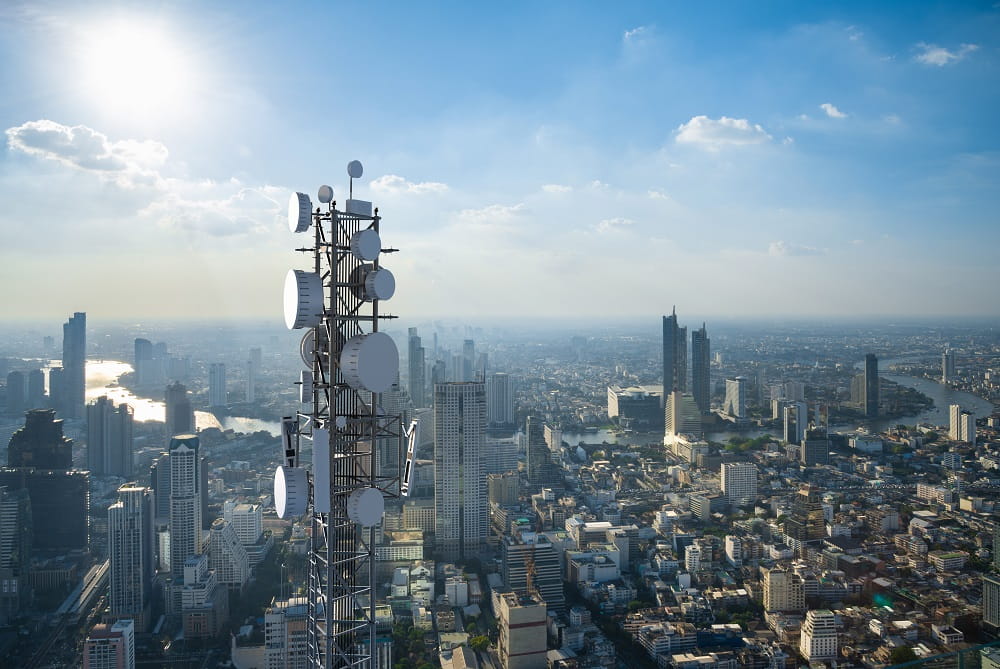 an aerial view of a city with telecommunication towers