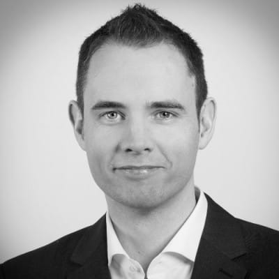 a black and white photo of a man in a suit